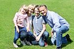 Lovable Family Posing In The Park Stock Photo