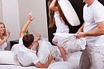 Lovely Family Having Fun On Their Bed In Living Room Stock Photo