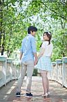 Loving Asian Couple Under Tree In The Park Stock Photo