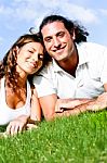 Loving Couple Lying In Lawn Stock Photo