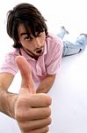 Lying Male showing Thumbs Up Stock Photo