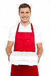 Male Chef Holding Pizza Box Stock Photo