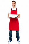 Male Chef Holding Pizza Box Stock Photo