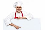 Male Chef Posing Behind Blank Board Stock Photo