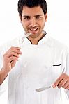 Male Chef Showing Eating Etiquettes Stock Photo