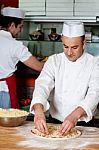 Male Chefs Working In Kitchen Stock Photo