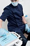 Male Dentist With Tools At Dental Clinic Stock Photo