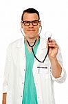 Male Doctor Showing Stethoscope Stock Photo