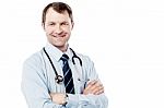 Male Doctor Standing With Folded Arms Stock Photo