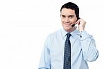 Male Employee Assisting Customer On Call Stock Photo