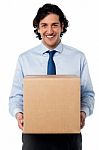 Male Executive Holding Cardboard Box Stock Photo