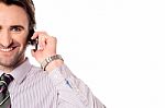 Male Executive Speaking Over Mobile Phone Stock Photo