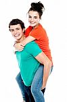 Male Giving Piggyback Ride Stock Photo