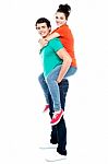 Male Giving Piggyback Ride Stock Photo