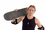 Male Holding Skateboard On Shoulder Stock Photo