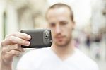 male Photographer With Mobile Phone Stock Photo