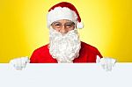 Male Santa Standing Behind Big Blank Banner Ad Board Stock Photo