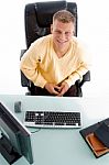 Male Sitting At Working Desk Stock Photo