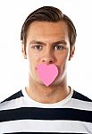 Male With Paper Heart On Mouth Stock Photo