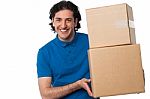 Man Carrying Couple Of Cardboard Boxes Stock Photo