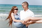 Man Carrying His Girl Friend Stock Photo