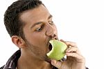 Man Eating Green Apple Stock Photo