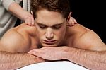 Man Getting Back Massage In Spa Salon Stock Photo