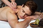 Man Getting Relaxing Massage In Spa Stock Photo