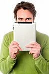 Man Hiding His Face With Tablet Device Stock Photo