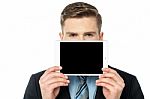 Man Hiding His Face With Tablet Device Stock Photo