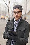 Man Holdin I-pad Tablet Computer On Street Stock Photo