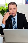 Man In Formal Attire Talking On The Phone Stock Photo