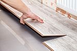 Man Laying Laminate Flooring Stock Photo