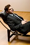 Man Lying On Chaise Longue Stock Photo