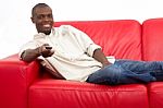 Man On The Sofa With Remote Control Stock Photo