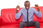 Man On The Sofa With Remote Control Rejoices Stock Photo