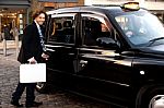 Man Opening Door Of Taxi Cab Stock Photo