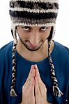 Man Praying With Woollen Cap Stock Photo