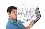 Man Reading News In Laptop Stock Photo