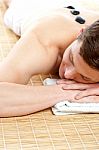 Man Receiving Stone Therapy Massage Stock Photo