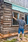 Man Repairing A Wooden House Stock Photo