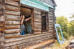 Man Repairing A Wooden House Stock Photo