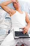 Man Resting With Laptop Stock Photo