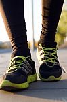 Man Shoes Running On The Asphalt With The Sky In The Background Stock Photo