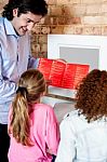 Man Showing Daughters How To Order Pizza Online Stock Photo