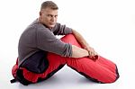 Man Sitting With Sleeping Bag Stock Photo