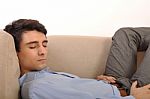 Man Sleeping On The Couch Stock Photo