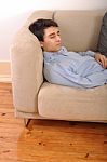 Man Sleeping On The Couch Stock Photo