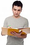 Man Studying With Dossier Stock Photo