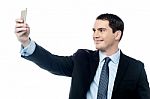 Man Taking Pictures Of Him Self With Smartphone Stock Photo